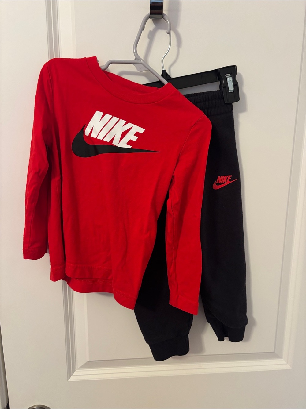 Nike Kids Black Joggers with Red Swoosh Logo